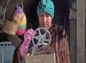 Clark Griswold in his attic reminiscing as he looks through old boxes of memorabilia