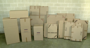 An array of perfectly labeled Arpin of RI wardrobes, dish barrels, and mirror boxes in a warehouse