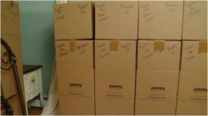 Image of carefully stacked Arpin of RI cartons in a fully packed bedroom