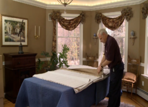 Arpin of RI packer in a dining room setting up export wrap onto the top of a protected dining table top