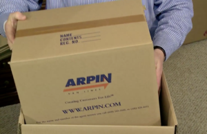 Arpin of RI packer placing a 1.5 carton which contains 12 fully wrapped figurines inside a dish barrel for double protection. 