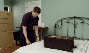 Arpin of RI packer packing a night stand with its drawer in a carton.